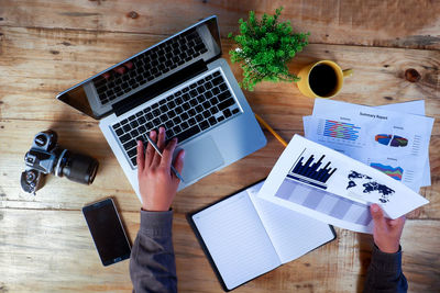 High angle view of man using laptop on table