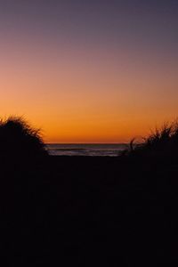 Scenic view of sea against clear sky during sunset