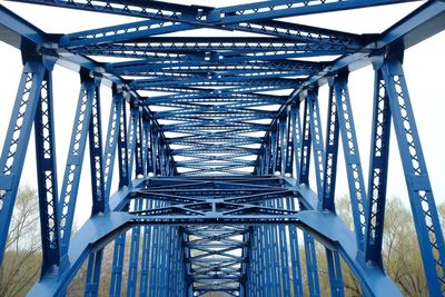 Low angle view of footbridge against sky