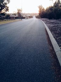 Empty road along trees