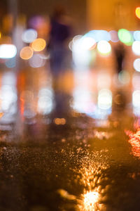 Defocused image of illuminated city street at night