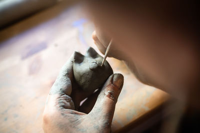 Close-up of hand holding painting