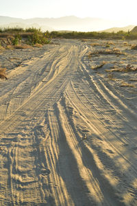 High angle view of tire tracks on desert