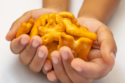 Cropped hands of woman holding food