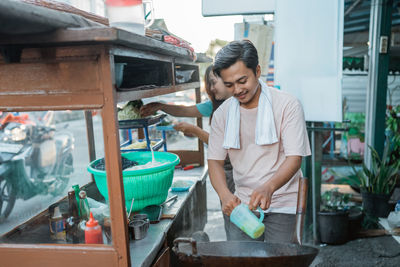 Side view of man working at market stall