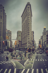 View of city street and buildings against sky