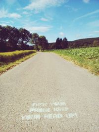 Road by landscape against sky