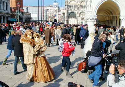 Group of people walking in front of buildings