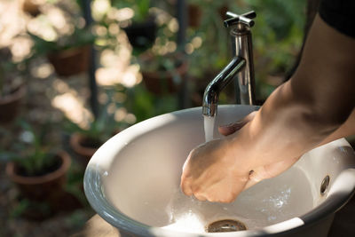 Midsection of person preparing food in kitchen