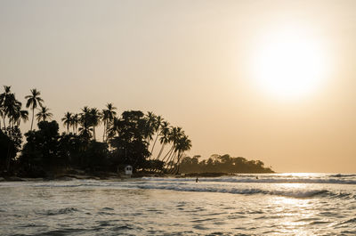 Scenic view of sea against clear sky at sunset