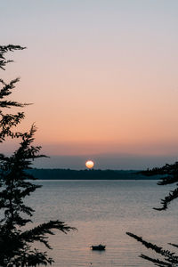 Scenic view of sea against clear sky during sunset