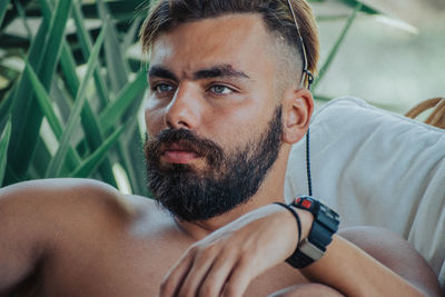 Close-up of man looking away sitting at home