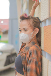 Portrait of young woman wearing mask