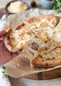 Homemade delicious hot pizza with chicken and slice with melting stretching cheese. 