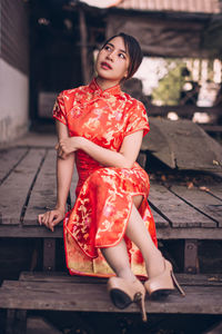 Full length of woman sitting outdoors