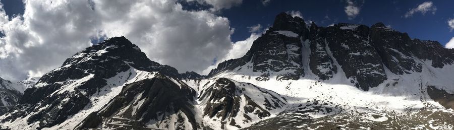 Low angle view of snowcapped mountains against sky