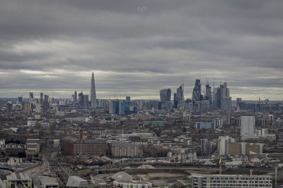 View of cityscape against cloudy sky