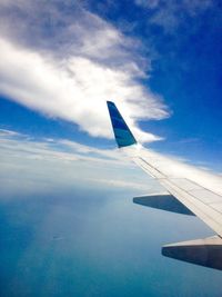 Cropped image of airplane against blue sky