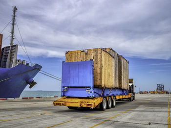 Ship moored at pier against sky