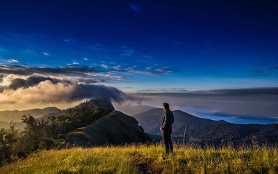 Man standing on land against sky