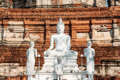 Statue outside temple against building