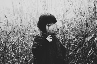 Full length of young woman standing on field
