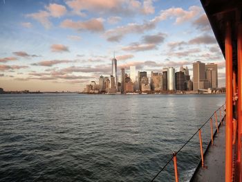 One world trade center and buildings by river seen from ferry