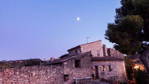 Low angle view of buildings against clear blue sky