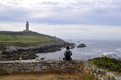 Man standing in front of sea against sky