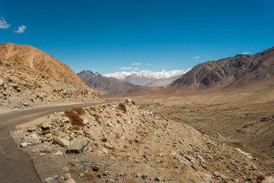 Scenic view of mountains against blue sky