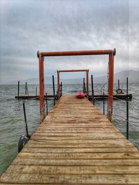 Pier over sea against sky