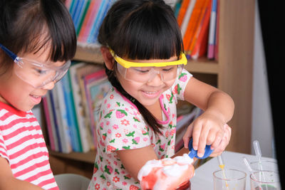 Close-up of girl playing with toys at home