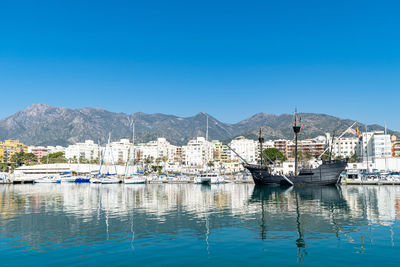 A black pirate style ship docked in the fishing port of marbella, spain