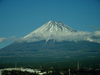 Scenic view of snowcapped mountains against blue sky