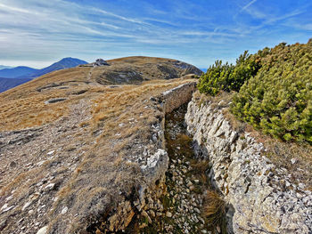 Scenic view of rocks in mountains against sky