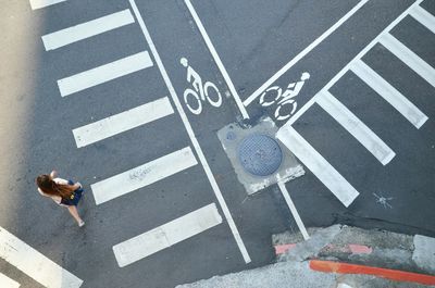 High angle view of woman walking on road