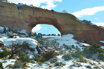 Scenic view of snow covered rock formation against sky