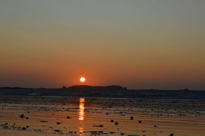 Scenic view of sea against clear sky during sunset