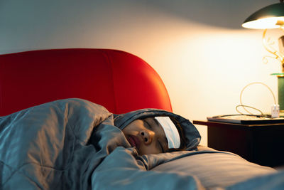 Portrait of man lying down on bed