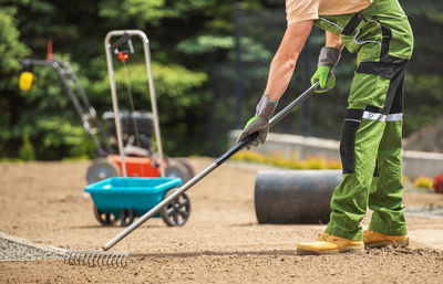 Low section of man working on field