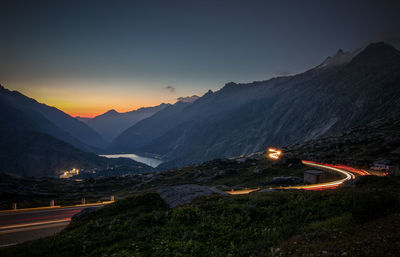 Evening mood on the grimsel pass with traces of light from the last motorcycle riders