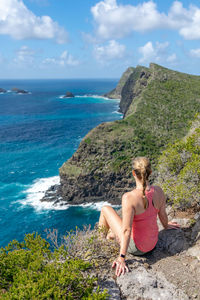 Woman looking at sea against sky