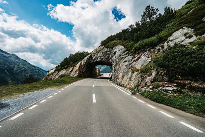 Road amidst mountains against sky