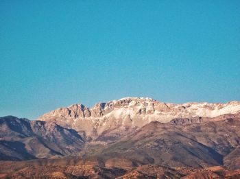 Scenic view of mountains against clear blue sky