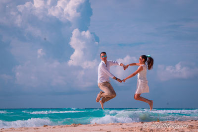 Full length of woman on beach against sky