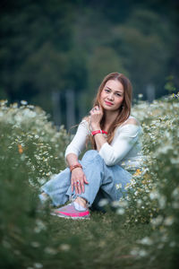 Portrait of young woman sitting outdoors