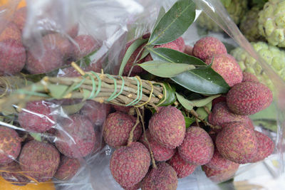 Close-up of lychees in plastic for sale at market