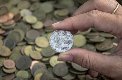 Cropped hand of person holding coin