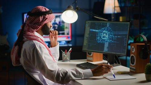 Midsection of woman using laptop at office