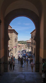 People walking on street amidst buildings in city